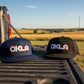 Two caps with 'OKLA' logo on a white background
