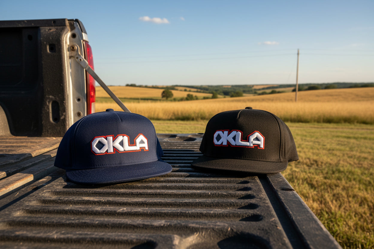 Two caps with 'OKLA' logo on a white background
