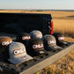 Collection of OKLA branded hats on a white background