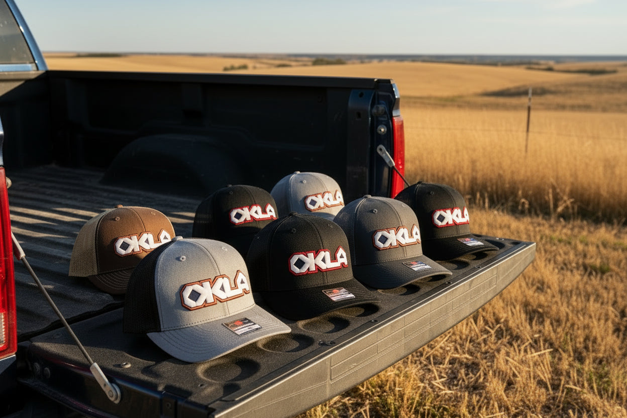 Collection of OKLA branded hats on a white background