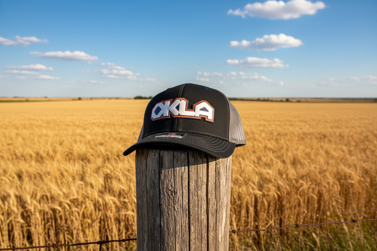Black trucker cap with 'OKLA' logo on a white background