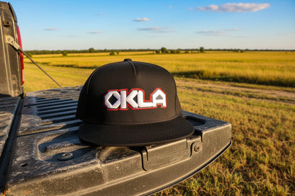 Black cap with 'OKLA' logo on a white background