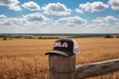 Black and white cap with 'OKLA' text on a gray background