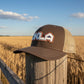 Brown trucker cap with 'OKLA' logo on a gray background
