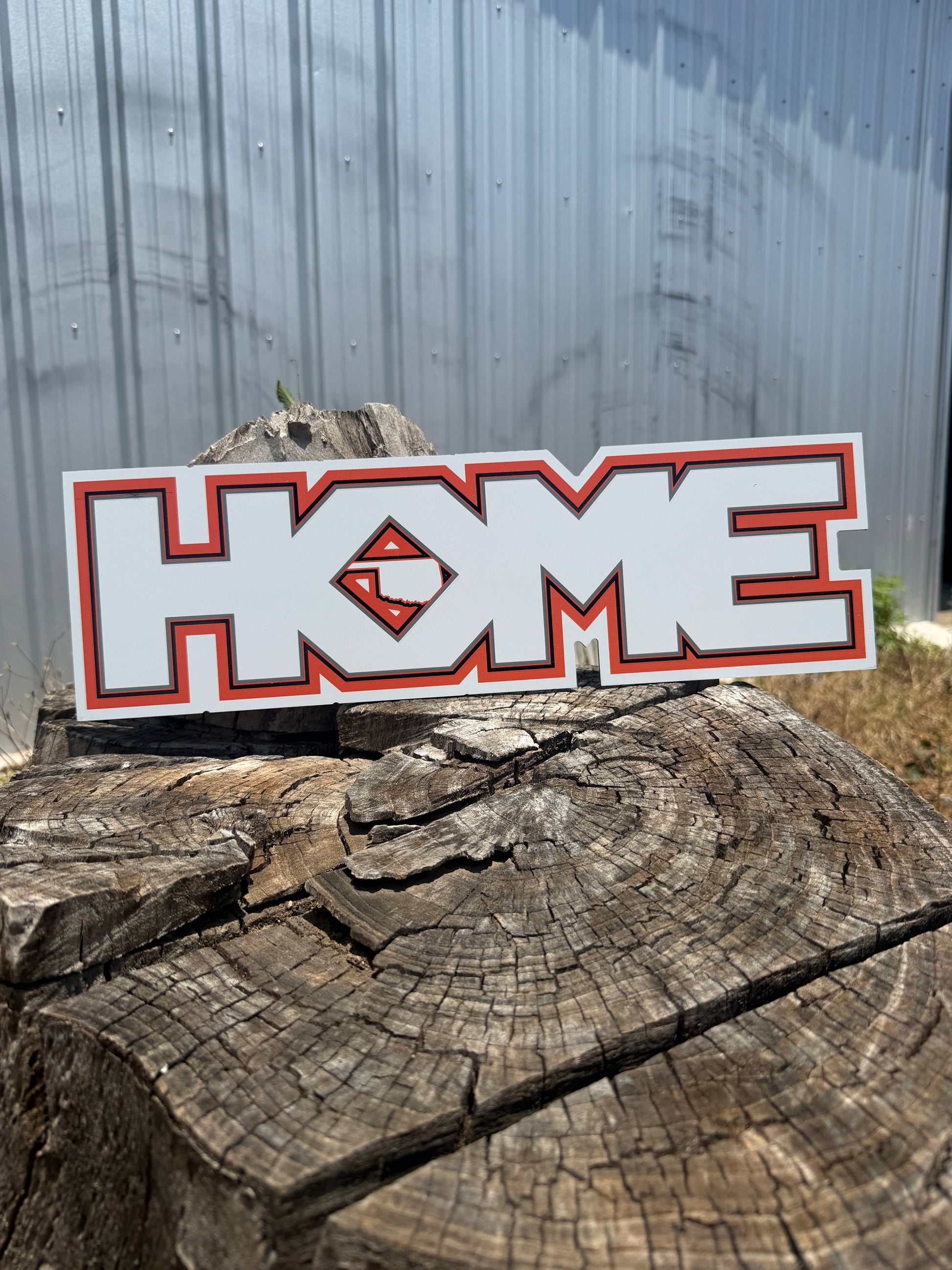 Sticker with a logo on a wooden log against a metal background