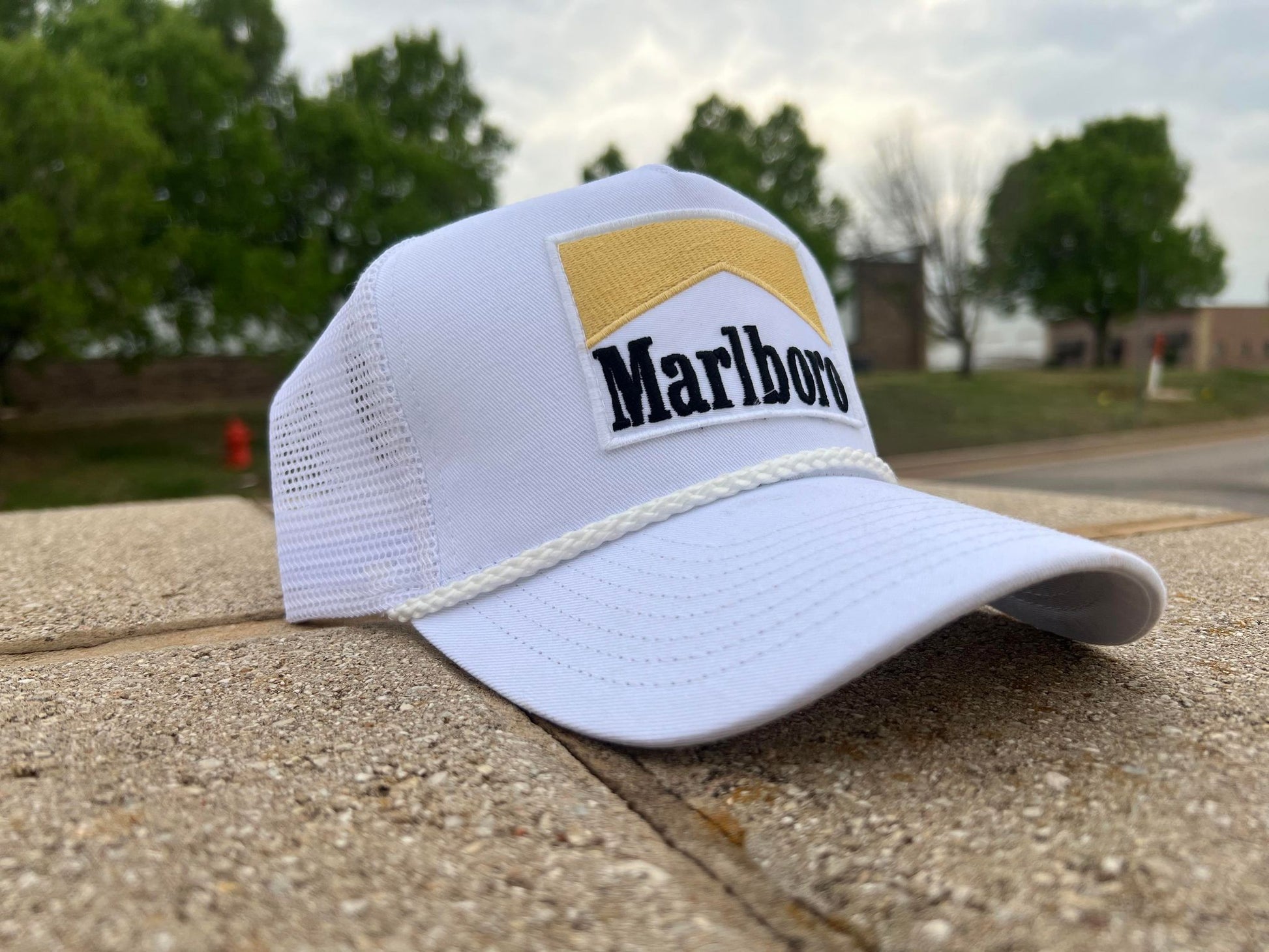 a marlboro hat sitting on the side of a road