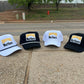 three hats sitting on the side of the road