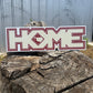 Decal with a logo on a wooden log against a metal background