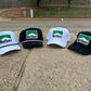 three hats sitting on the side of a road