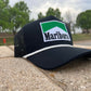 a marlboro trucker hat sitting on a ledge