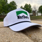 a marlboro hat sitting on top of a stone wall